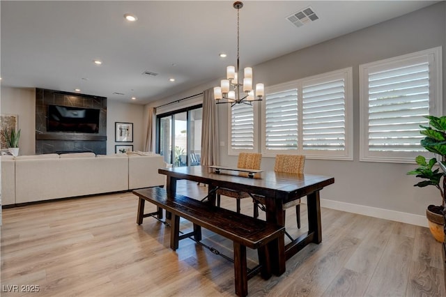 dining room featuring light wood-style flooring, a chandelier, baseboards, and recessed lighting