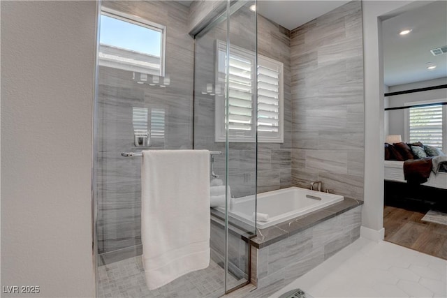full bath with ensuite bathroom, a stall shower, and a bath
