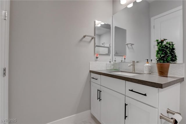 bathroom featuring vanity, baseboards, and marble finish floors