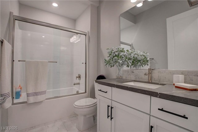 bathroom with marble finish floors, toilet, combined bath / shower with glass door, and vanity