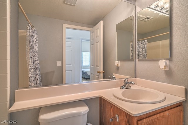 2920 Riarosa Ct, North Las Vegas, NV 89086 - full bath with toilet, a textured wall, vanity, and a shower with curtain