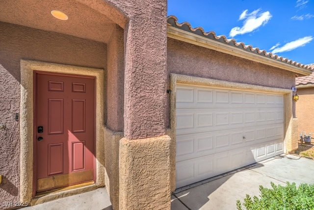 2920 Riarosa Ct, North Las Vegas, NV 89086 - view of exterior entry featuring stucco siding and a garage