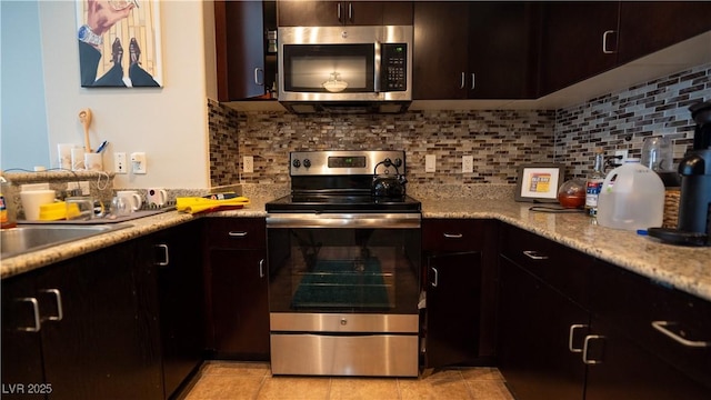 8255 S Las Vegas Blvd Unit 1514, Las Vegas, NV 89123 - kitchen featuring stainless steel appliances, light countertops, tasteful backsplash, and a sink