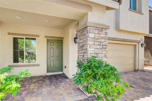 1055 Fish Pond Ave, Henderson, NV 89014 - entrance to property with stucco siding, an attached garage, and stone siding