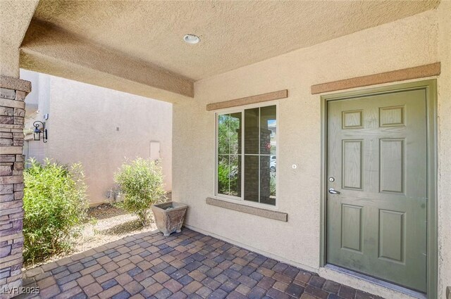 1055 Fish Pond Ave, Henderson, NV 89014 - doorway to property featuring stucco siding