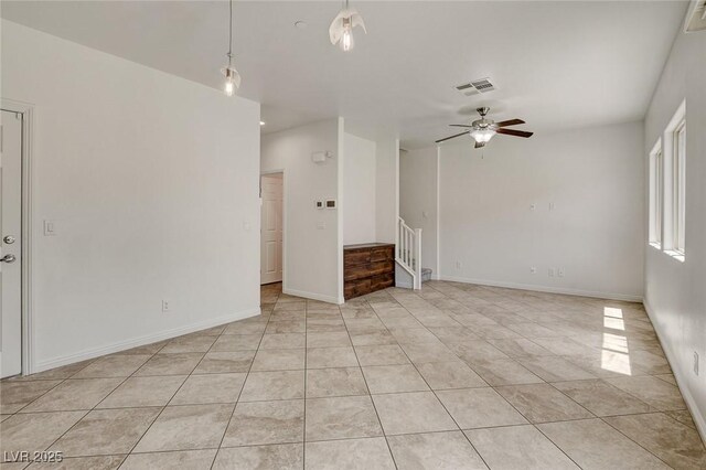 1055 Fish Pond Ave, Henderson, NV 89014 - unfurnished room featuring a ceiling fan, stairs, light tile patterned floors, and baseboards