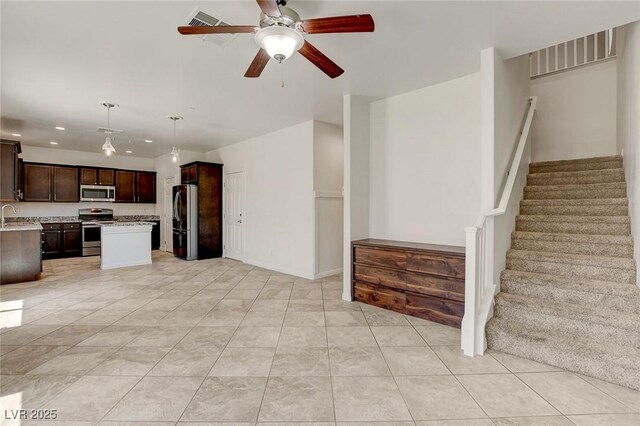 1055 Fish Pond Ave, Henderson, NV 89014 - kitchen with appliances with stainless steel finishes, recessed lighting, light countertops, dark brown cabinetry, and a ceiling fan