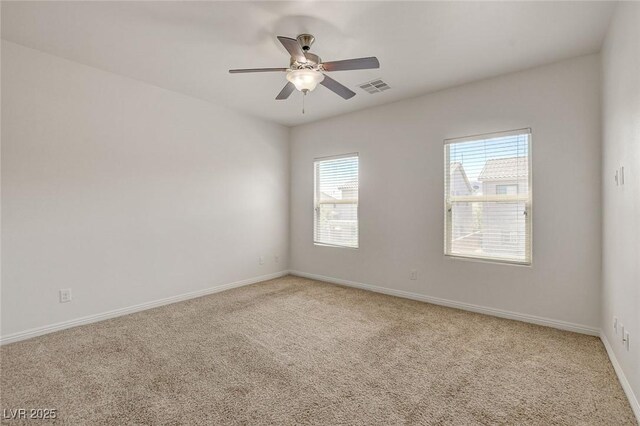 1055 Fish Pond Ave, Henderson, NV 89014 - spare room with light colored carpet, a ceiling fan, and baseboards