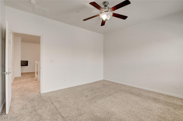 1055 Fish Pond Ave, Henderson, NV 89014 - spare room with light colored carpet, a ceiling fan, and baseboards
