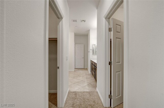 1055 Fish Pond Ave, Henderson, NV 89014 - corridor with baseboards, light tile patterned floors, and light carpet