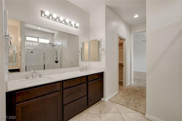1055 Fish Pond Ave, Henderson, NV 89014 - full bathroom featuring a shower stall, baseboards, a walk in closet, double vanity, and recessed lighting