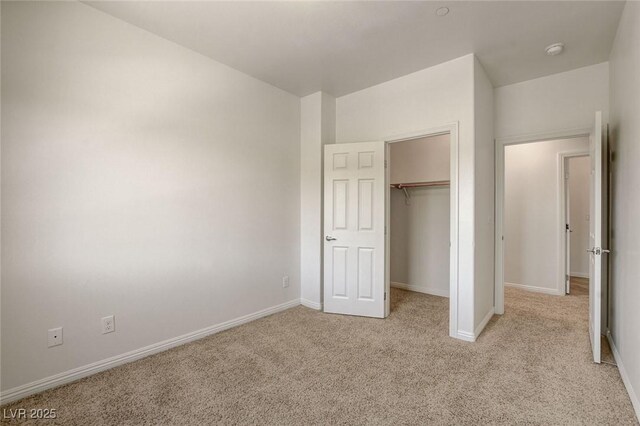 1055 Fish Pond Ave, Henderson, NV 89014 - unfurnished bedroom featuring light carpet, baseboards, and a closet