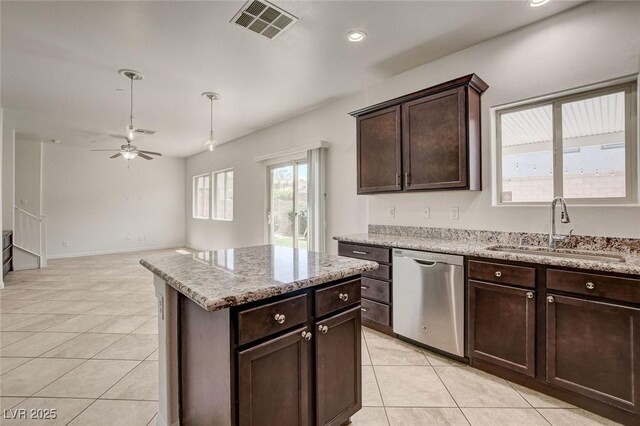 1055 Fish Pond Ave, Henderson, NV 89014 - kitchen featuring stainless steel dishwasher, a sink, light tile patterned floors, a ceiling fan, and dark brown cabinets