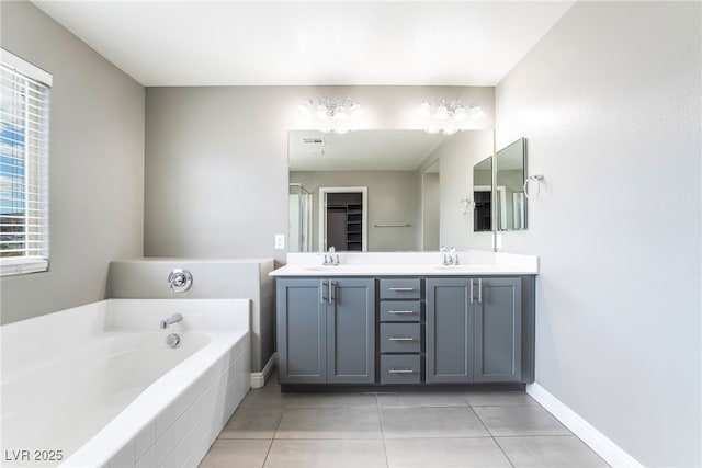 5981 Smith Valley Rd, Las Vegas, NV 89148 - full bath featuring a bath, tile patterned flooring, double vanity, and baseboards