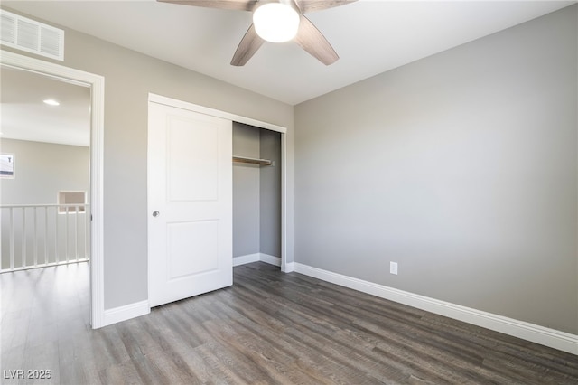 5981 Smith Valley Rd, Las Vegas, NV 89148 - unfurnished bedroom featuring dark wood-style flooring, baseboards, a closet, and a ceiling fan