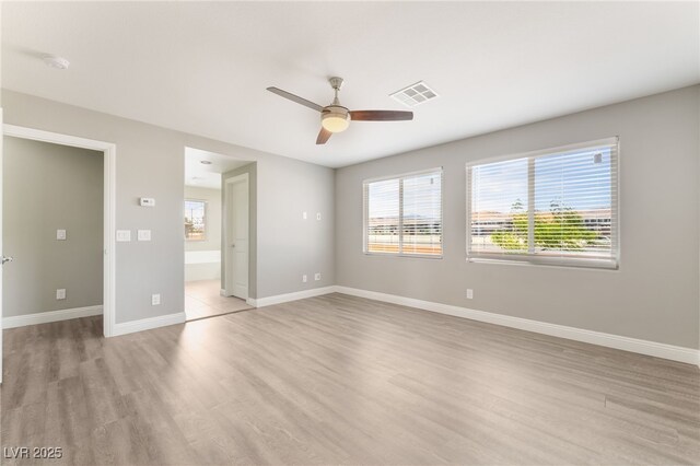 5981 Smith Valley Rd, Las Vegas, NV 89148 - unfurnished bedroom featuring light wood-style flooring, multiple windows, and baseboards