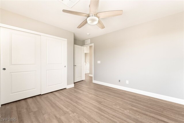 5981 Smith Valley Rd, Las Vegas, NV 89148 - unfurnished bedroom featuring baseboards, wood finished floors, a closet, and ceiling fan
