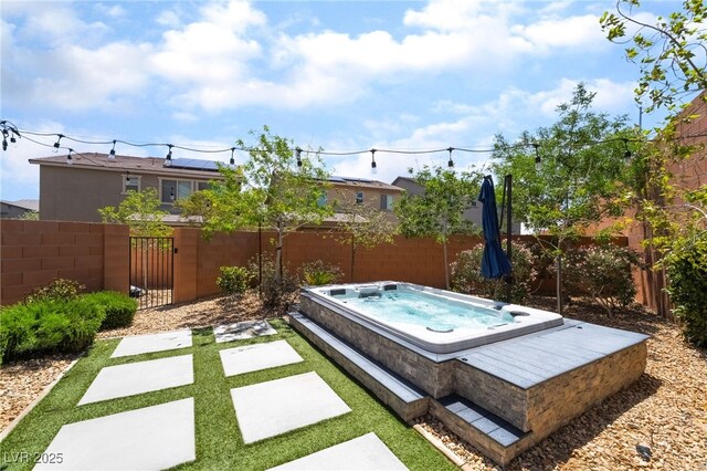 5981 Smith Valley Rd, Las Vegas, NV 89148 - fenced yard with an outdoor hot tub and a gate