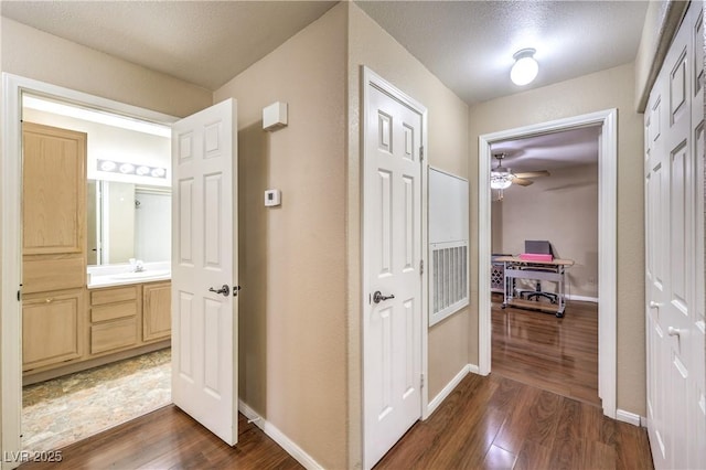 1557 Lake Placid Ter Unit 1557, Henderson, NV 89014 - corridor with dark wood finished floors, a desk, baseboards, and a sink