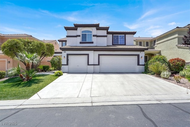 mediterranean / spanish-style house featuring an attached garage, stucco siding, concrete driveway, and a tiled roof