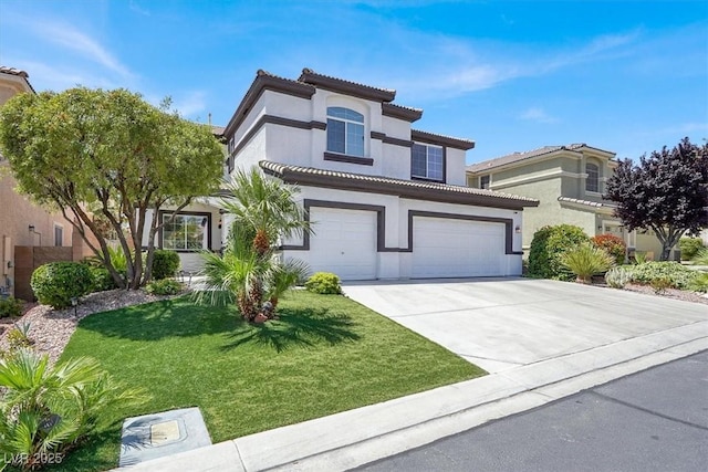 mediterranean / spanish home featuring a tiled roof, stucco siding, a garage, concrete driveway, and a front yard