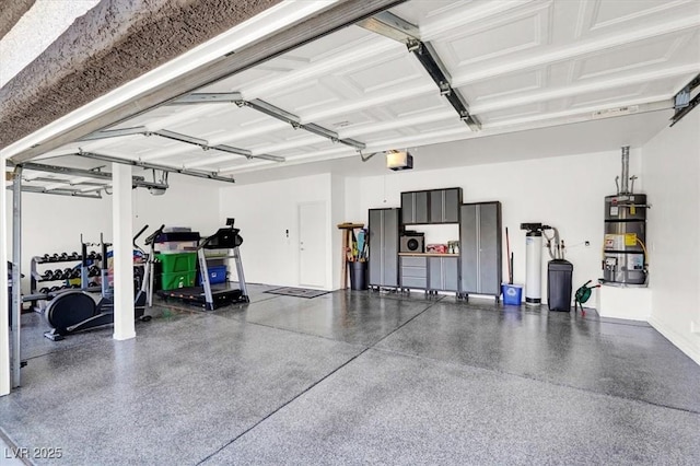 garage featuring secured water heater and a garage door opener