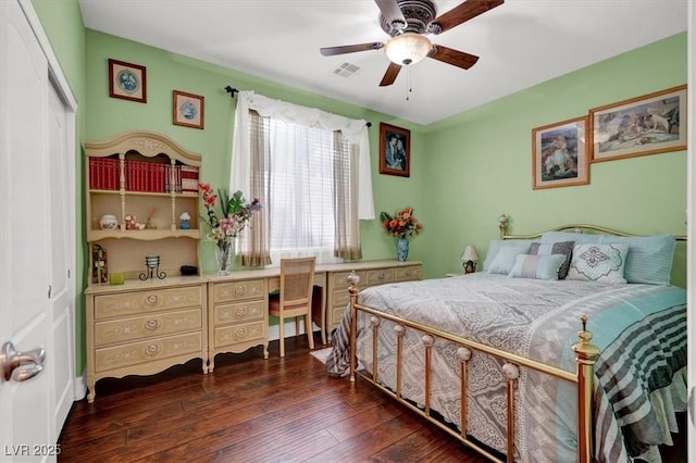 bedroom with dark wood-style floors, a closet, ceiling fan, and an office area