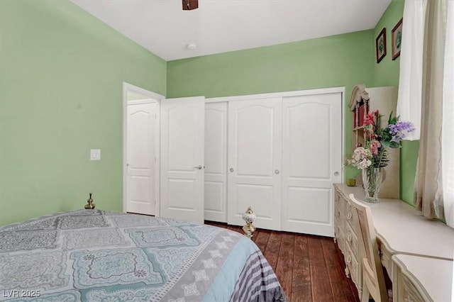 bedroom featuring dark wood-type flooring, a closet, and ceiling fan