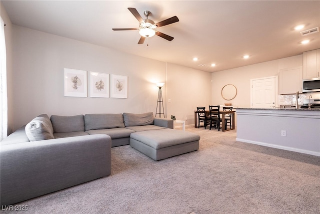 living area featuring a ceiling fan, carpet flooring, and recessed lighting