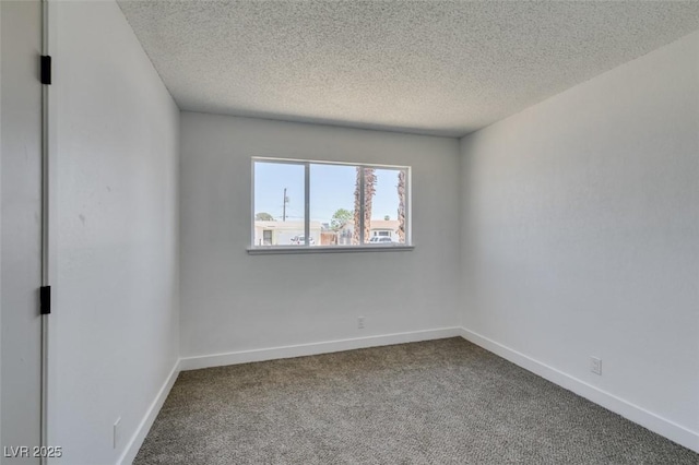 212 View Dr, Las Vegas, NV 89107 - empty room featuring dark colored carpet, a textured ceiling, and baseboards
