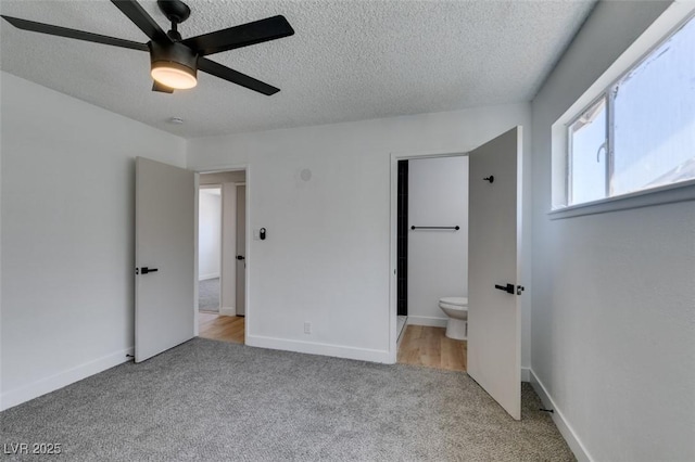 212 View Dr, Las Vegas, NV 89107 - unfurnished bedroom featuring a textured ceiling, carpet, ensuite bathroom, and a ceiling fan