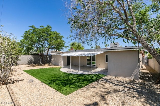 212 View Dr, Las Vegas, NV 89107 - rear view of property with stucco siding, a patio area, and a fenced backyard