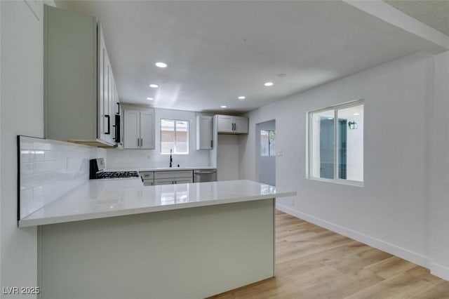 212 View Dr, Las Vegas, NV 89107 - kitchen featuring stove, stainless steel dishwasher, a peninsula, light countertops, and recessed lighting