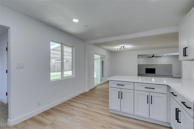 212 View Dr, Las Vegas, NV 89107 - kitchen with a peninsula, light countertops, light wood-style floors, ceiling fan, and baseboards