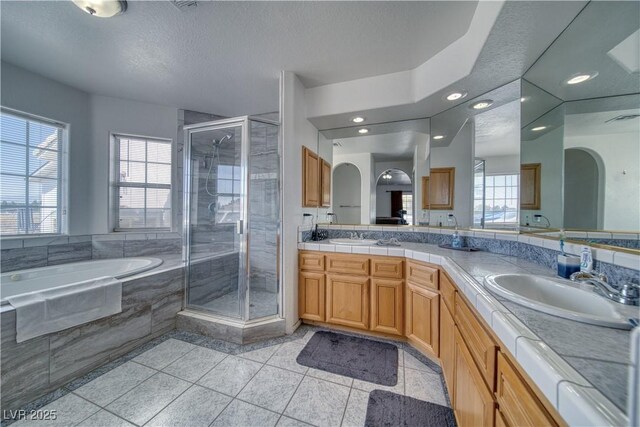 3581 Margarita Ave, Pahrump, NV 89048 - full bath with a garden tub, a shower stall, double vanity, tile patterned floors, and recessed lighting