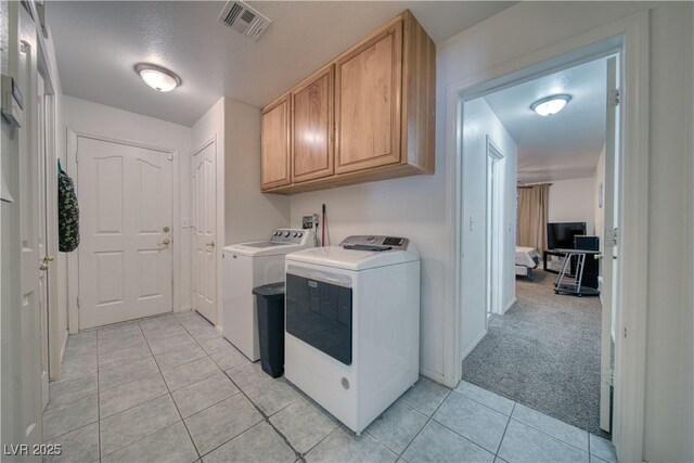 3581 Margarita Ave, Pahrump, NV 89048 - washroom featuring light tile patterned flooring, washer and clothes dryer, and cabinet space