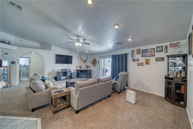 3581 Margarita Ave, Pahrump, NV 89048 - living room featuring light colored carpet, arched walkways, a ceiling fan, baseboards, and vaulted ceiling