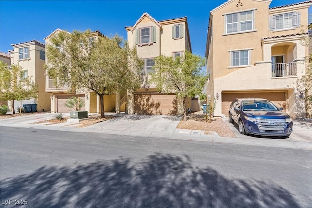 multi unit property with stucco siding and an attached garage