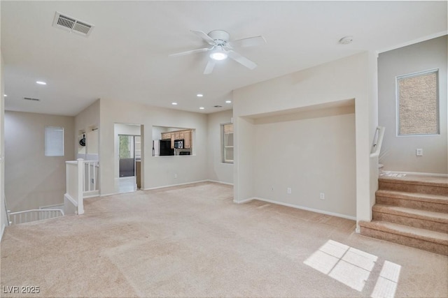 unfurnished living room featuring light carpet, a ceiling fan, recessed lighting, and baseboards