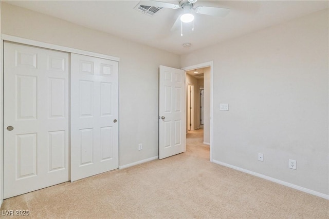 unfurnished bedroom with light carpet, baseboards, a closet, and ceiling fan