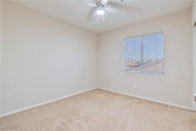 spare room with light carpet, baseboards, and ceiling fan