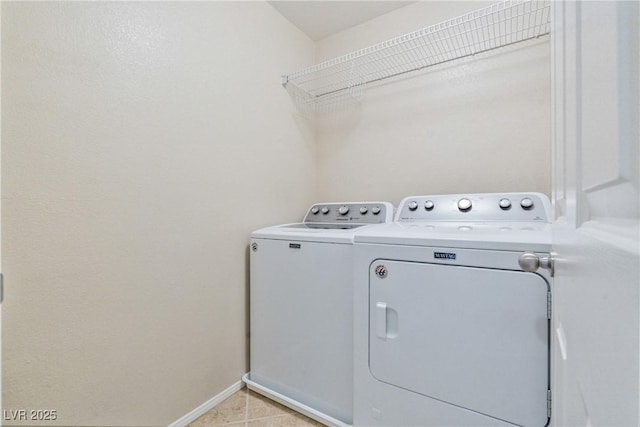 laundry area with independent washer and dryer and baseboards