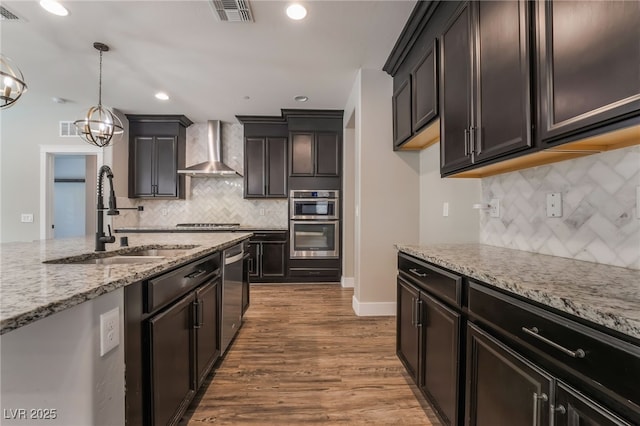133 Clouded Ave, Henderson, NV 89002 - kitchen featuring wall chimney range hood, a sink, stainless steel appliances, tasteful backsplash, and light stone counters