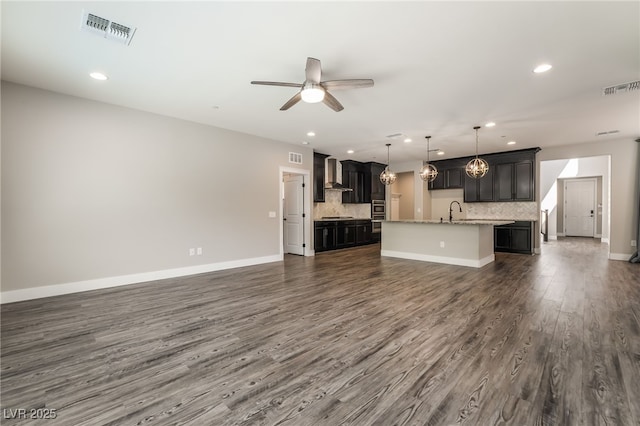 133 Clouded Ave, Henderson, NV 89002 - unfurnished living room with a ceiling fan, recessed lighting, dark wood-style floors, baseboards, and a sink