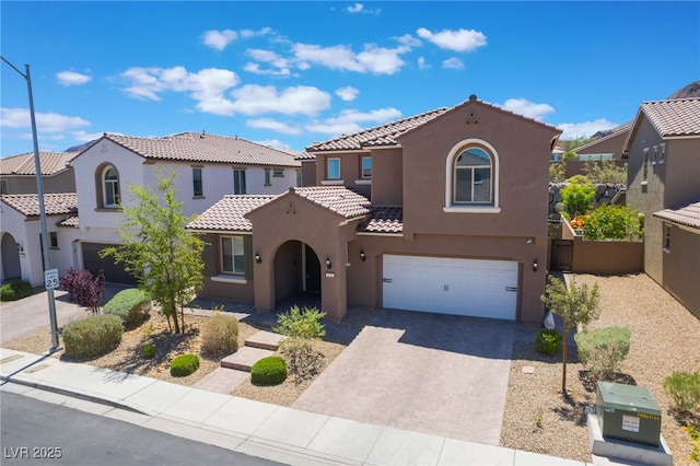 133 Clouded Ave, Henderson, NV 89002 - mediterranean / spanish house featuring stucco siding, an attached garage, driveway, and a tiled roof