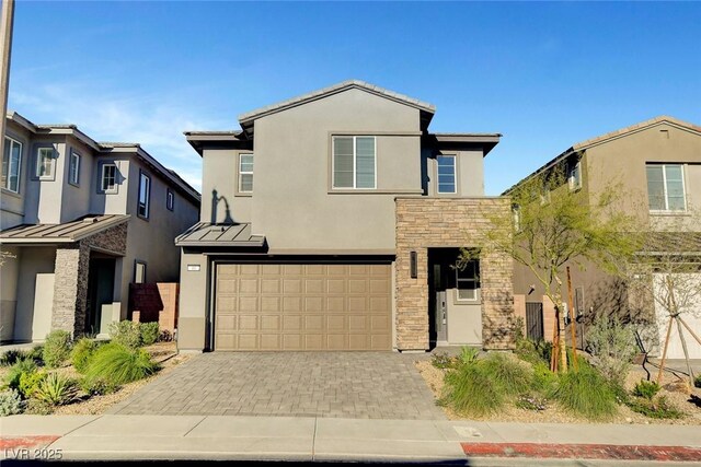 40 Strada Moscato, Henderson, NV 89011 - traditional-style home with stucco siding, stone siding, an attached garage, a standing seam roof, and decorative driveway