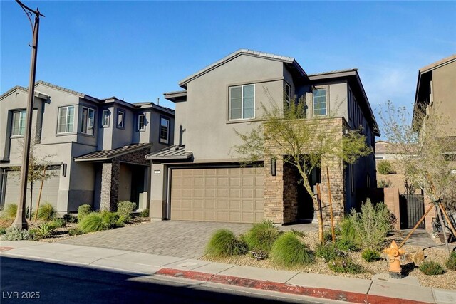 40 Strada Moscato, Henderson, NV 89011 - view of front facade with a garage, stucco siding, a standing seam roof, metal roof, and driveway