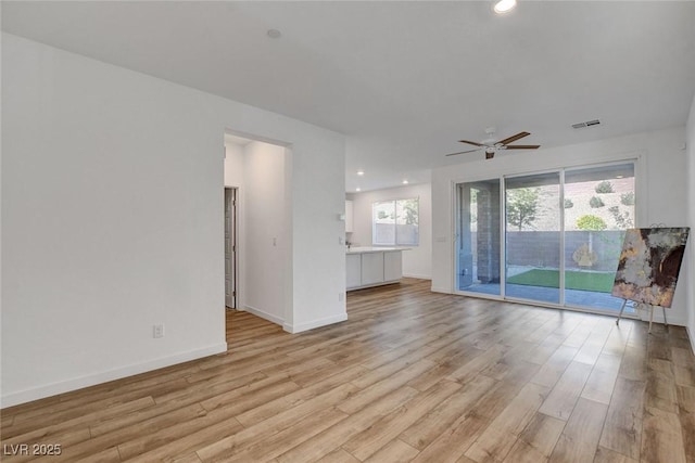 40 Strada Moscato, Henderson, NV 89011 - unfurnished living room with light wood-type flooring, a ceiling fan, baseboards, and recessed lighting