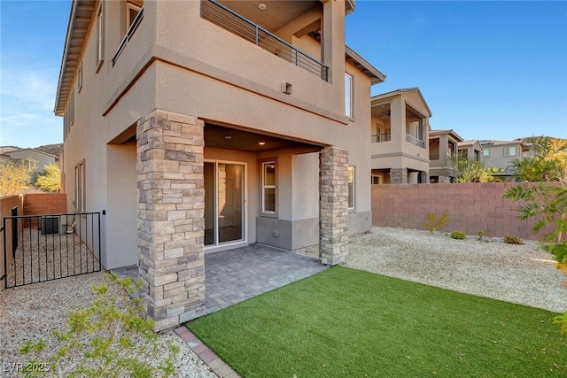 40 Strada Moscato, Henderson, NV 89011 - property entrance featuring stucco siding, stone siding, fence, and a patio area