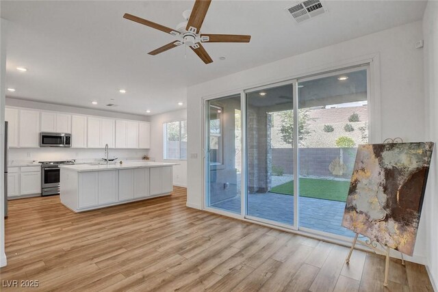 40 Strada Moscato, Henderson, NV 89011 - kitchen featuring appliances with stainless steel finishes, light wood-style flooring, white cabinets, a ceiling fan, and recessed lighting